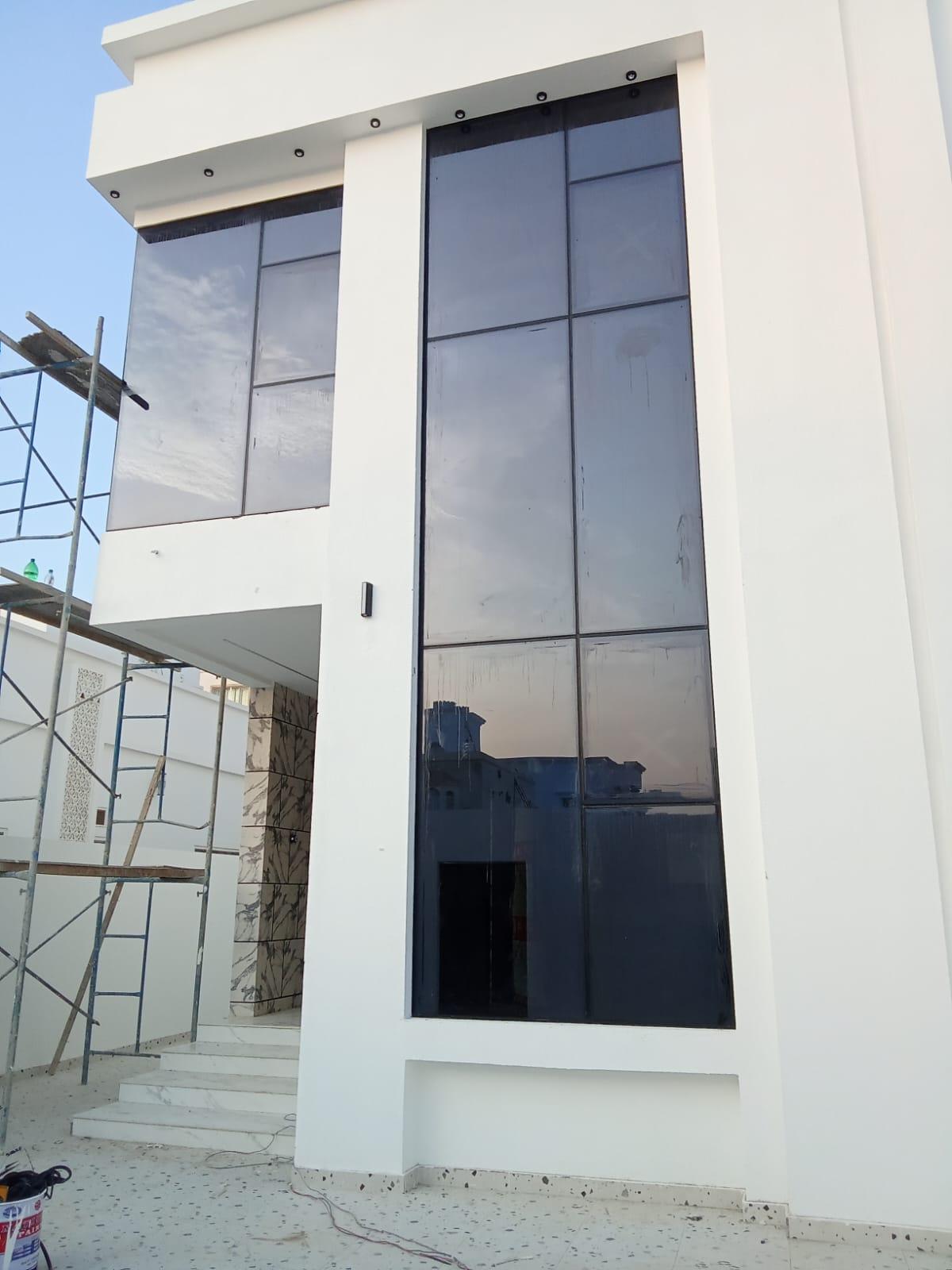 Tinted aluminium curtain wall on a commercial building in Oman