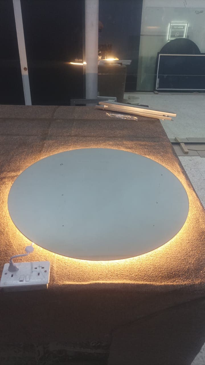 Circular LED backlit bathroom mirror cut by Oman Glass House