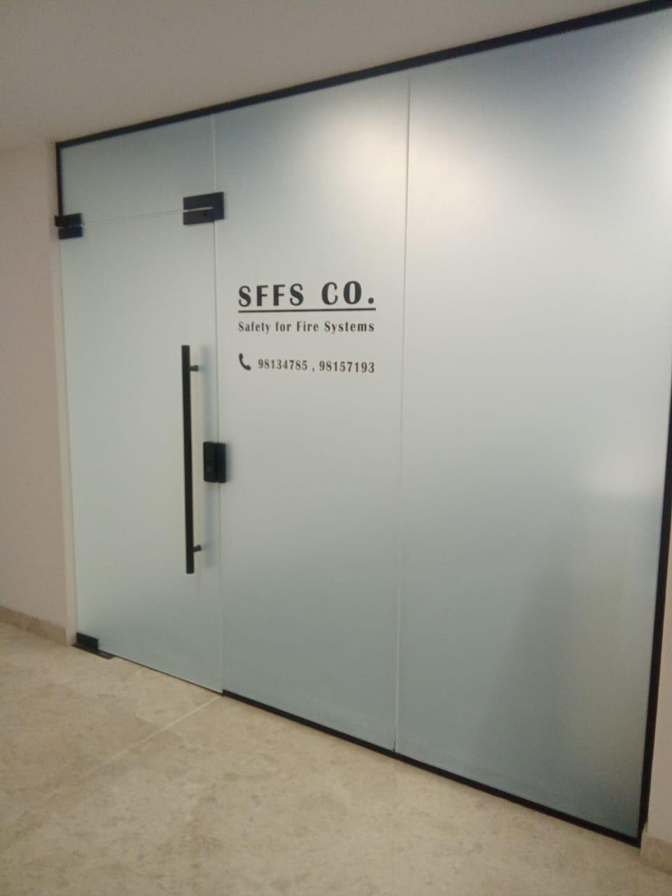 Frosted office glass door with black frame in a Muscat fit-out