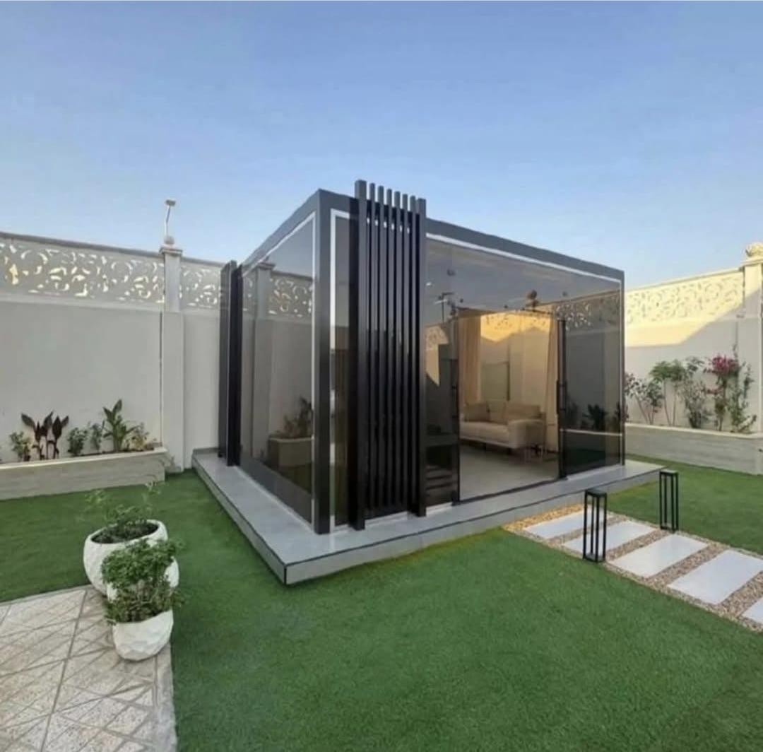 Black-frame garden glass house with floor-to-ceiling sliding door